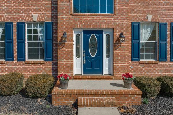 Brick home with blue door and shutters